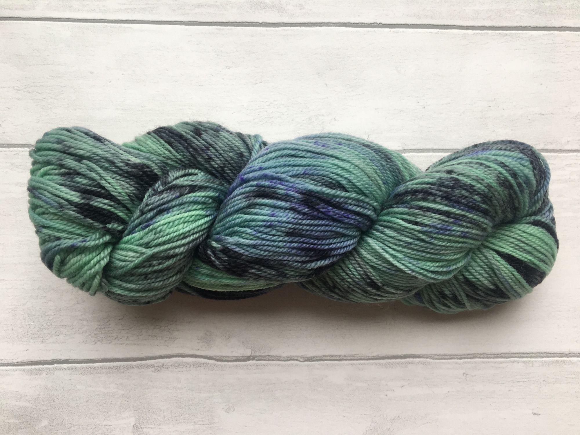 Green Yarn with Black and Purple Patches