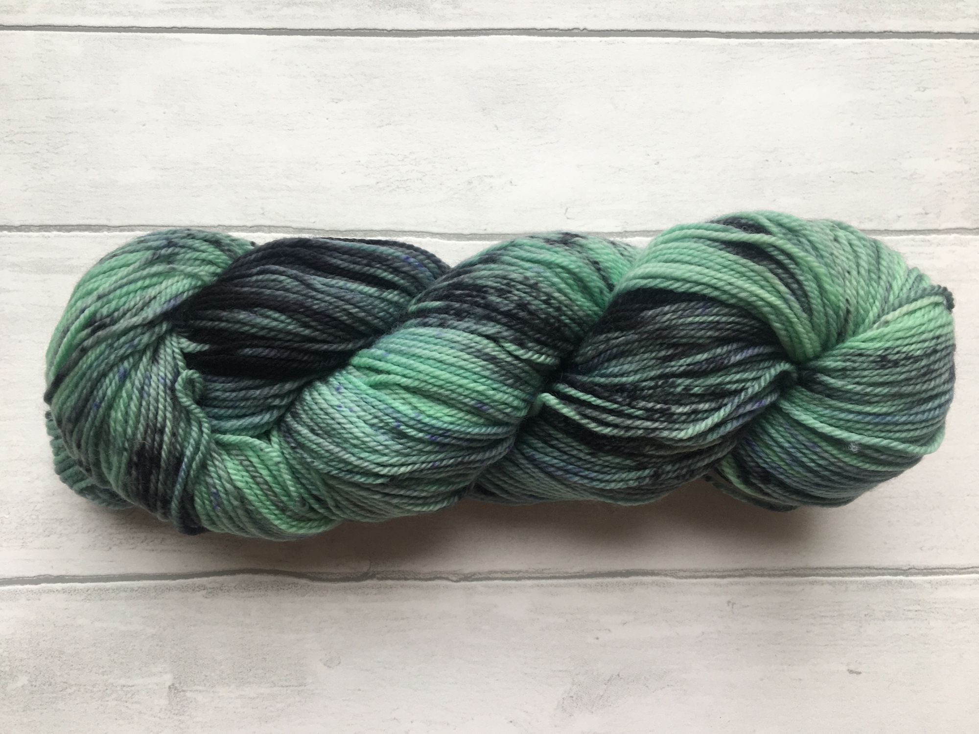 Green Yarn with Black and Purple Patches