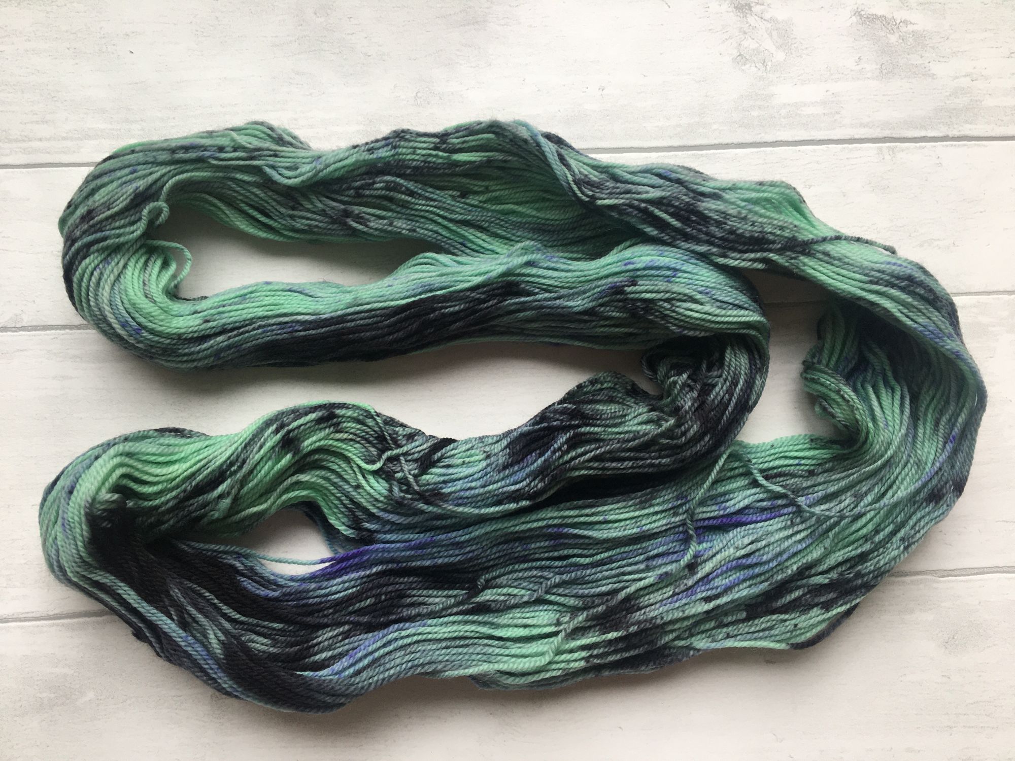 Green Yarn with Black and Purple Patches