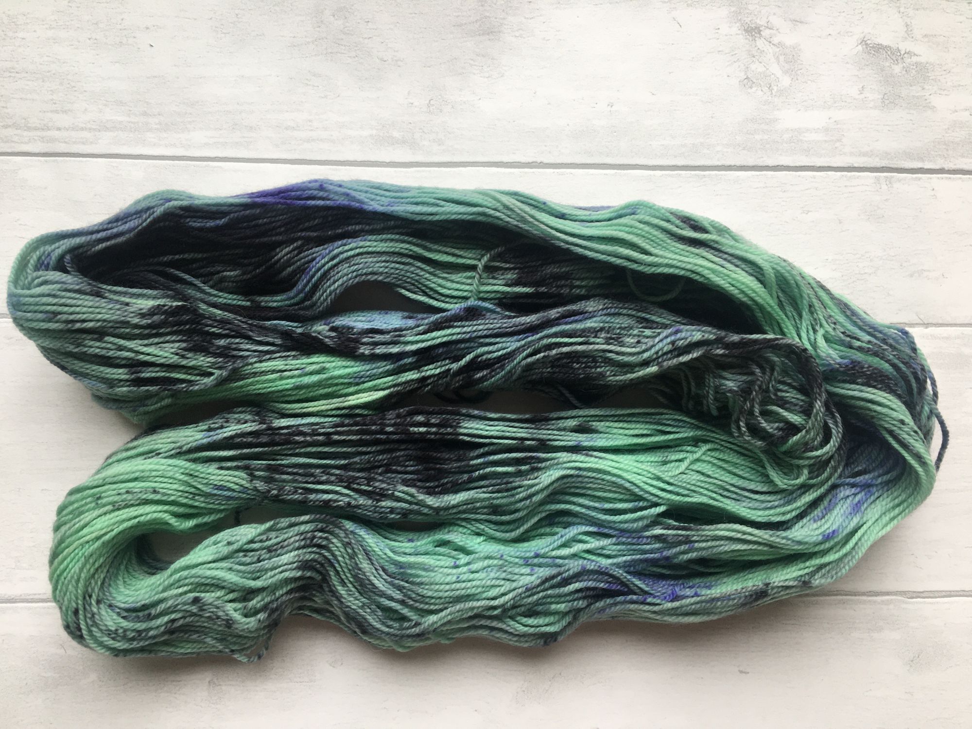 Green Yarn with Black and Purple Patches